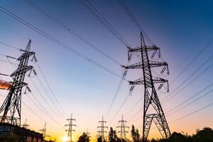 Power lines at the sunset background. High voltage pole mountain in the evening. High-voltage line, super cool sunset concept photo