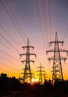 Power lines at the sunset background. High voltage pole mountain in the evening. High-voltage line, super cool sunset concept photo