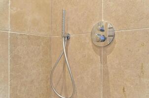 A shower head with a hose attached to it photo