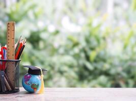Student creative desktop, Colorful stationery and earth globe with graduation hat. Copy space for text, Back to school, Education concept photo