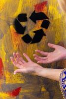 Yellow metal barrel with recycling symbol. Container with sign. waste. Disposal, utilization problem photo