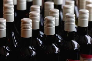 Storage of quality wine bottles with screw caps in a wine rack Close up photo