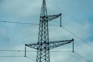 High voltage towers with sky background. Power line support with wires for electricity transmission. High voltage grid tower with wire cable at distribution station. Energy industry, energy saving photo