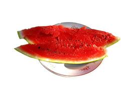 Slices of ripe watermelon on a plate - color photo, isolate for design photo