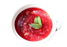 Turkish national refreshing summer drink raspberry-cranberry sherbet with spices with mint leaves in porcelain dishes with handles - color photo, isolate for design photo
