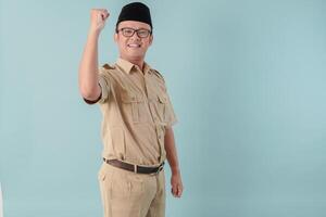 Energetic Indonesian government worker man raising her hands in the air with happy expression. photo