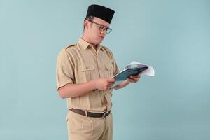 Young government worker man reading document paper or report with serious expression. photo