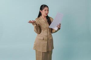 Beautiful Indonesian government worker woman holding a document report with confused expression. photo