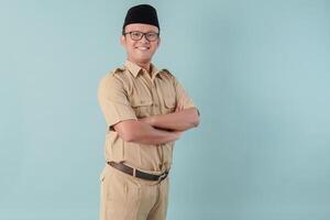 Confident government worker man wearing khaki uniform smiling and standing with his arms crossed. photo