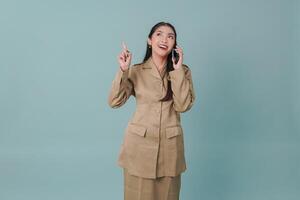 Happy government worker woman while talking on the phone and pointing to the copy space upward. photo