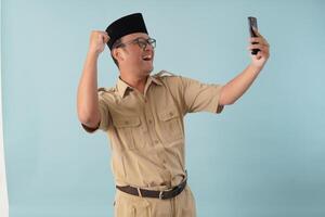 Indonesian government worker man doing call with a happy successful expression. photo