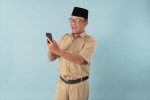 Cheerful government worker man wearing khaki uniform using smartphone to browse internet. photo