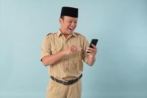 Cheerful government worker man wearing khaki uniform using smartphone to browse internet. photo