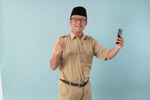 Indonesian government worker man doing call with a happy successful expression. photo