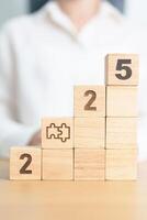 2025 year block with jigsaw puzzle icon. Business Process, Team, teamwork, Goal, mission, Resolution, strategy, plan, Action, partnership, and New Year start photo