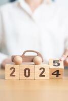 2024 end year to Happy New Year 2025 with Car model on table. Automobile Tax, Car Insurance, Financial, vehicle Repair and Maintenance and New Year concept photo