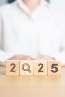 2025 block with magnifying glass icon. SEO, Search Engine Optimization, hiring , Advertising, Idea, Strategy, marketing, Keyword, Content and New Year start concepts photo
