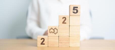 2025 year block with jigsaw puzzle icon. Business Process, Team, teamwork, Goal, mission, Resolution, strategy, plan, Action, partnership, and New Year start photo