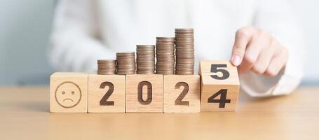 2024 end year to Happy New Year 2025 with Coins stack and Sad icon. goal, Money, Budget, investment, financial, savings, New Year Resolution, Satisfaction, feedback, Review and bad year concept photo