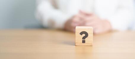 Wood block of Questions Mark sign. FAQ, frequency asked questions, Answer, Q and A, Information, Communication and interrogation Concepts photo