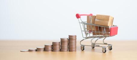 Boxes with shopping cart and money coins stack. online shopping, Marketplace platform website, technology, ecommerce, shipping delivery, logistics and online payment concepts photo
