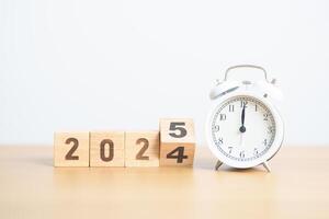 2024 end year to Happy New Year 2025 with vintage alarm clock. Christmas, New Start, Resolution, countdown, Goals, Plan, Action and Motivation Concept photo