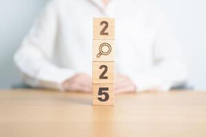 2025 block with magnifying glass icon. SEO, Search Engine Optimization, hiring , Advertising, Idea, Strategy, marketing, Keyword, Content and New Year start concepts photo