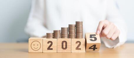 2024 end year to Happy New Year 2025 with Coins stack and Smile icon. goal, Money, Budget, investment, financial, savings, New Year Resolution, Satisfaction, feedback, Review and good year concept photo