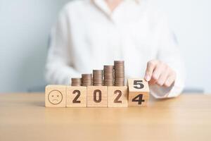 2024 end year to Happy New Year 2025 with Coins stack and Sad icon. goal, Money, Budget, investment, financial, savings, New Year Resolution, Satisfaction, feedback, Review and bad year concept photo