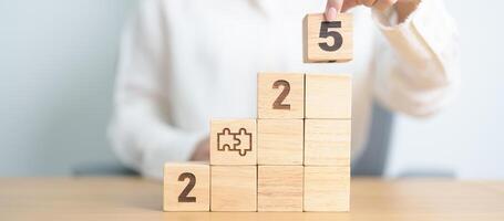 2025 year block with jigsaw puzzle icon. Business Process, Team, teamwork, Goal, mission, Resolution, strategy, plan, Action, partnership, and New Year start photo