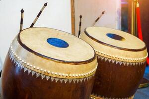Glong thad is a Thai drum. It is a large double-sided drum with 2 balls, one making a high sound and the other making a low sound. Used to play in the Piphat band, playing with Tapone. photo