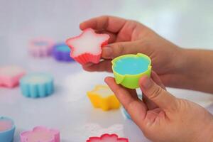 Handmade soap bars in various shapes of silicone molds. The colorful, beautiful products are handmade from a science workshop held by Thai students. photo