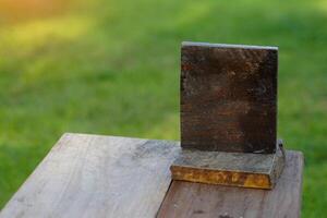 small square wooden board, there is space for writing or attaching table numbers, attached to the menu, attached to the QR code for payment, looks chic, suitable for restaurants, coffee shops. photo