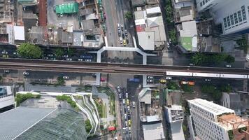 Morning traffic at the intersection with the BTS Skytrain in downtown Bangkok video