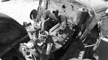 Black and White Engine Compartment of Old Vehicle Rusting in California Desert photo