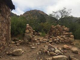 Ruins of an Abandoned Stone Cabin in Arizona Desert photo