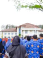 defocus or blur image of Indonesian civil servants standing and lining up in the city hall yard in order to attend a ceremony. copy space concept photo