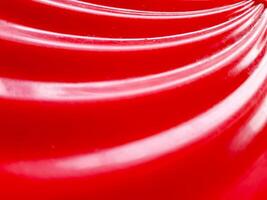Glossy abstract background with red color. defocused and close up of red plastic tube texture for abstract background and design. photo