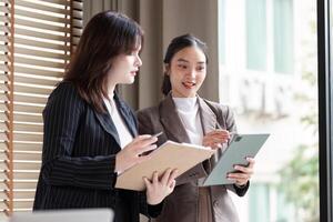 Business Analysts Collaborating on Digital Strategies with Tablet Devices photo