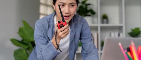 Female Engineer Communicating via Radio for Effective Project Coordination in Office photo