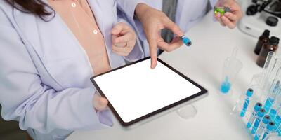 Scientists Utilize Tablet and Lab Resources for Collaborative Research Methodology photo