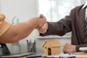 Successful Real Estate Deal Handshake Between Agent and Client photo