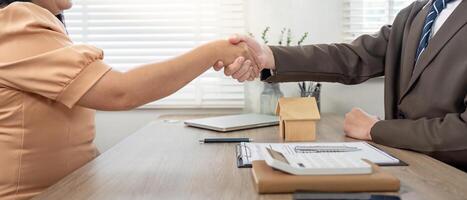 Real Estate Agent Closing a Property Deal with Client in Office Setting photo