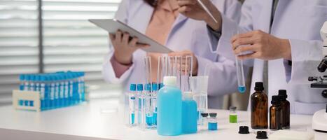 Lab Technicians Handling Specimens and Digital Data for Experiment Documentation photo