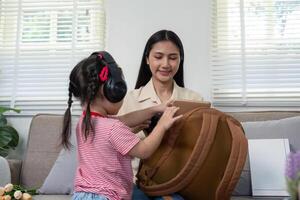 Mother Preparing Child for School with Backpack Organization photo