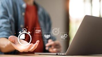 Businessman showing virtual icon in hand, time management concept,effective business planning,time management in the organization,Agreement and solution photo