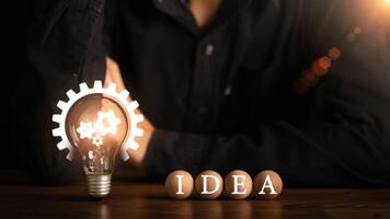 concept with innovation and inspiration, innovative technology in science concept and modern business development ,creative idea ,Businessman points at light bulb showing new idea ,problem solving photo