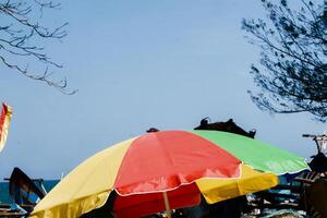 a colorful umbrella on the beach photo