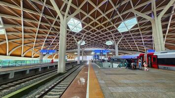 a train station with a large roof and a train photo