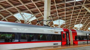 a train is parked at a station with a roof photo